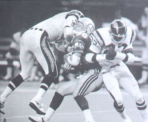 Seattle Seahawks receiver Steve Largent (80), center, holds the ball after  catching a touchdown pass from Dave Krieg in the first quarter of the game  against the Los Angeles Raiders in Seattle